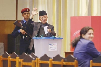 Presidential candidate Subhas Nembang of the Communist Party of Nepal (Unified Marxist-Leninist) waves before casting his vote for Nepal's new president in Kathmandu, Nepal, on Thursday.