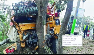 MADUKHALI (Faridpur): A highway police stand in front of a smashed truck at Madhukhali in Faridpur on Thursday as the loaded truck lost control and got stuck with a tree leaving one person dead.