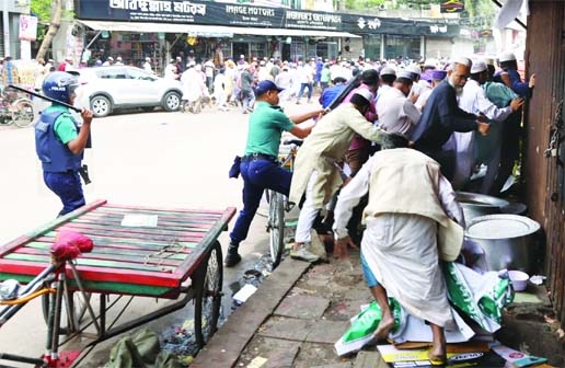 Police charge batons on Muslim devotees when they brought out a rally under the banner of 'Islamic Law Implementation Committee' at Purana Paltan area in the capital on Friday.